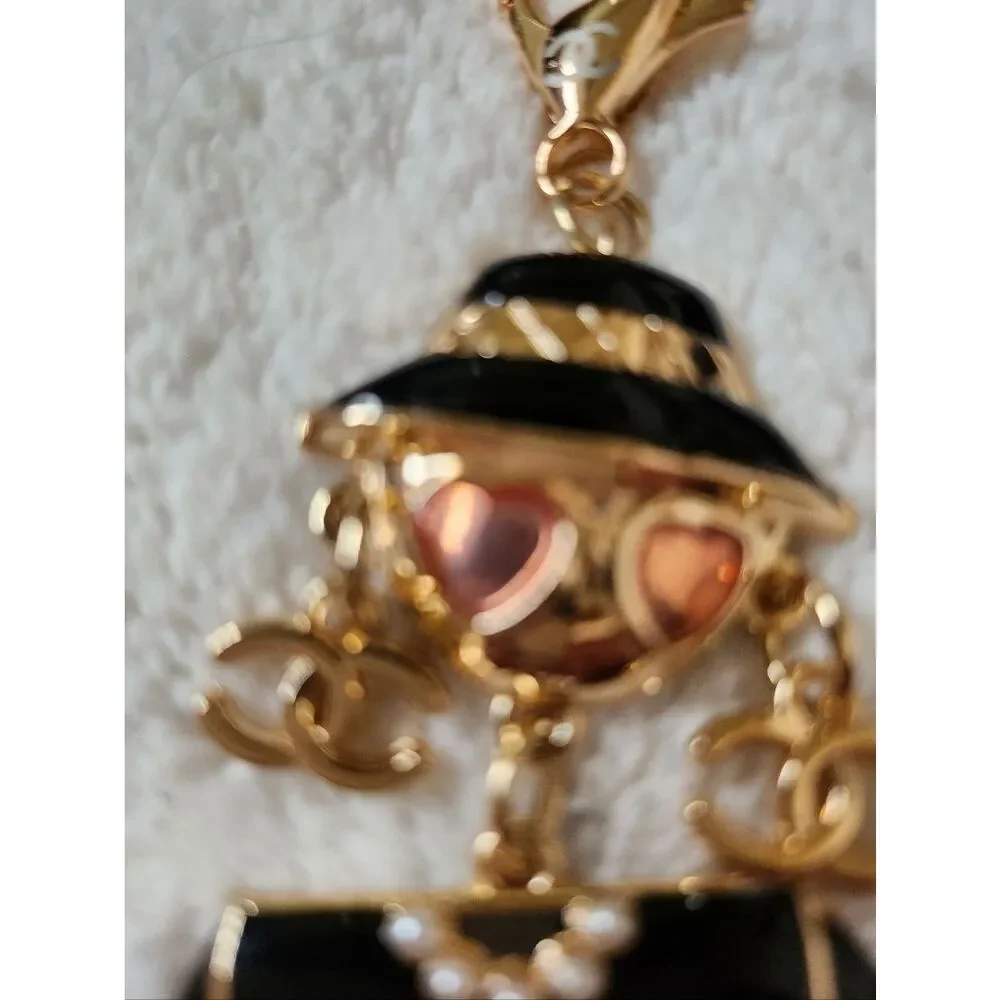 CHANEL Black and Gold Enamel Charm Doll with Pink Heart Sunglasses
